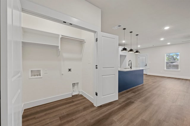 laundry area featuring washer hookup, gas dryer hookup, dark wood-type flooring, and hookup for an electric dryer