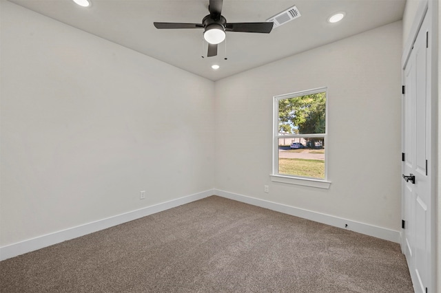 carpeted empty room featuring ceiling fan