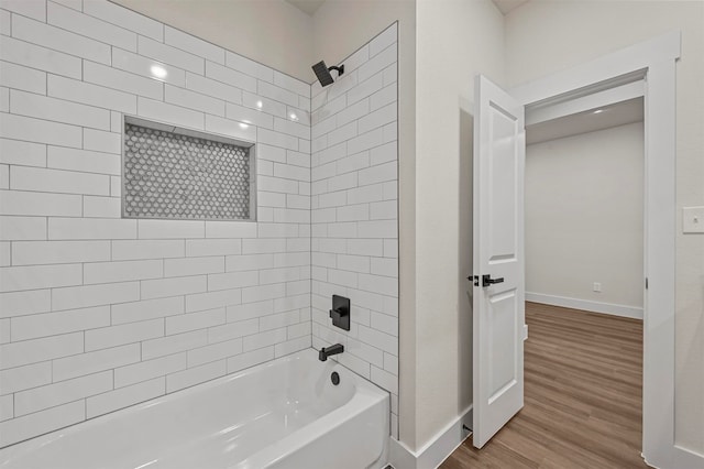 bathroom with wood-type flooring and tiled shower / bath combo