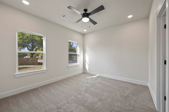 carpeted spare room featuring ceiling fan