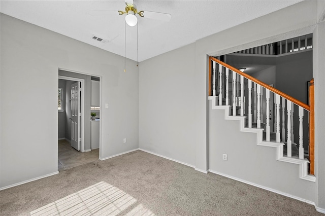 unfurnished room featuring carpet flooring and ceiling fan