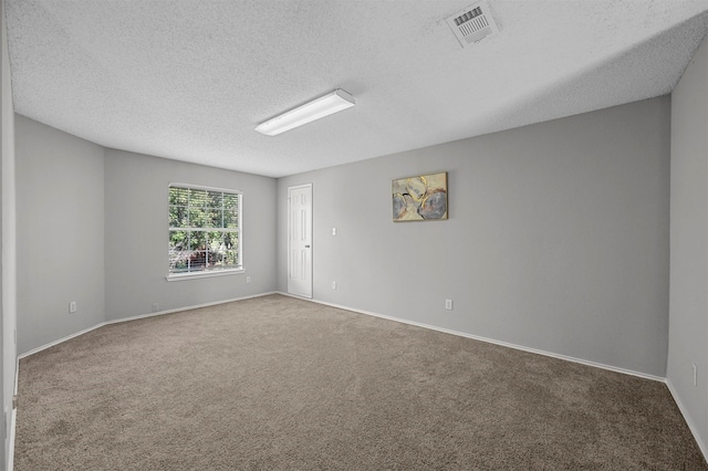 carpeted spare room with a textured ceiling