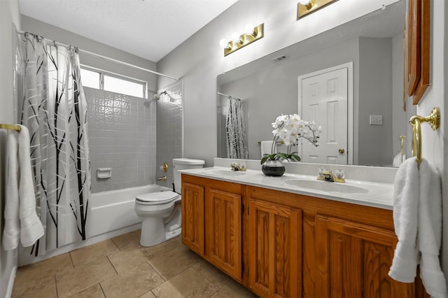 full bathroom featuring vanity, toilet, a textured ceiling, and shower / bath combo