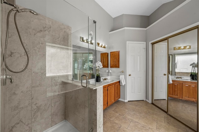 bathroom featuring a healthy amount of sunlight, walk in shower, and vanity