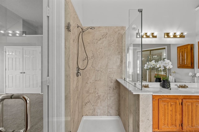 bathroom featuring walk in shower, vanity, vaulted ceiling, and a textured ceiling