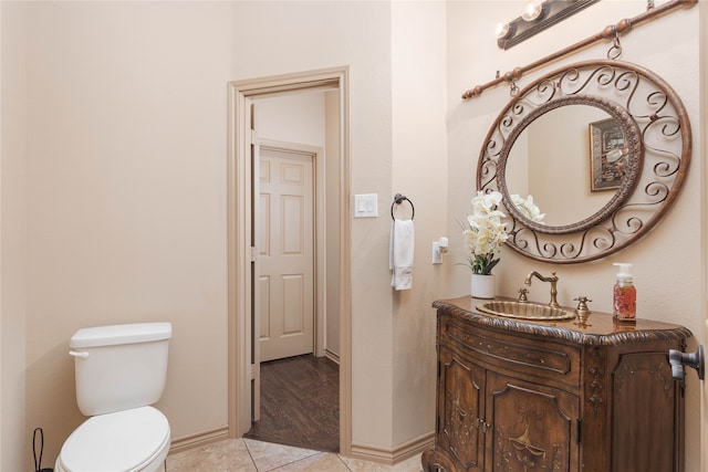 bathroom featuring tile patterned floors, vanity, and toilet