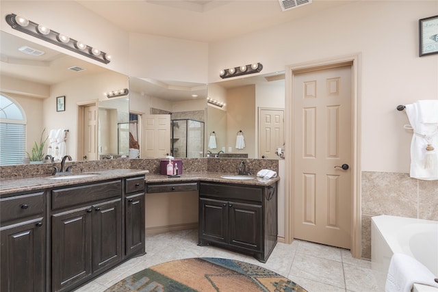 bathroom with tile patterned floors, vanity, and shower with separate bathtub