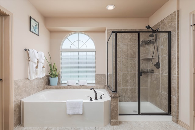 bathroom featuring tile patterned flooring and separate shower and tub