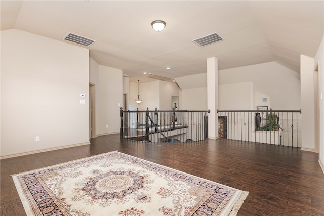 spare room featuring vaulted ceiling and dark wood-type flooring