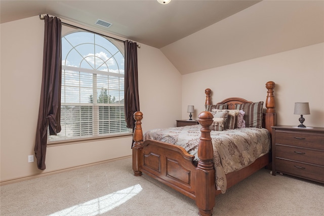 bedroom featuring light colored carpet and vaulted ceiling