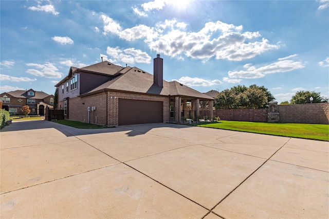 view of front of house with a front lawn and a garage