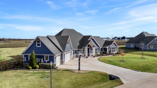 craftsman inspired home featuring a garage and a front lawn