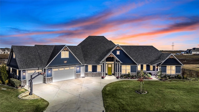 craftsman-style house with a garage and a yard