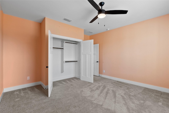 unfurnished bedroom with ceiling fan, light colored carpet, and a closet