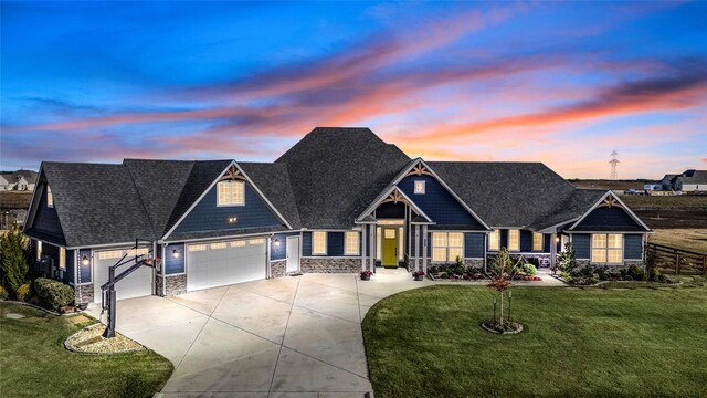 craftsman house with a garage and a yard