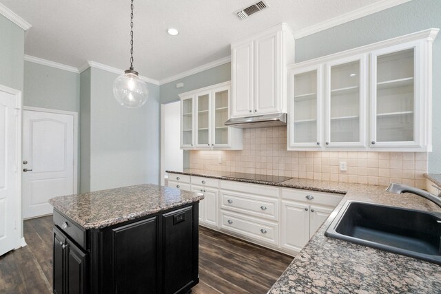 kitchen featuring a kitchen island, sink, hanging light fixtures, stainless steel refrigerator, and white double oven