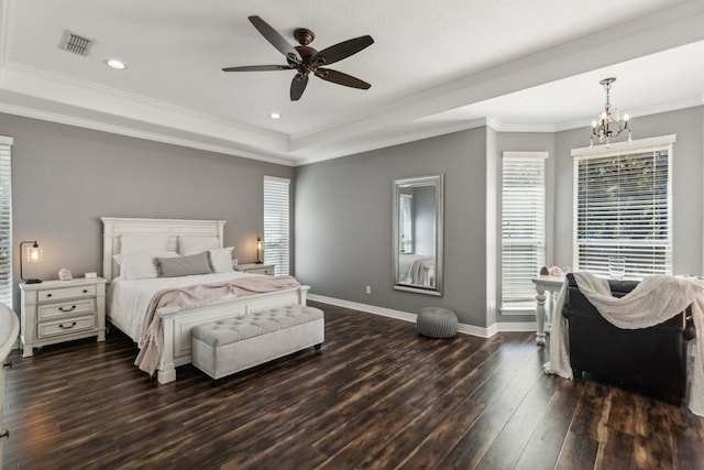 bedroom with crown molding, dark hardwood / wood-style flooring, ceiling fan with notable chandelier, and a raised ceiling