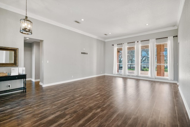 unfurnished living room with crown molding, dark wood-type flooring, and a chandelier