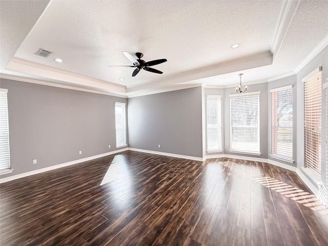 spare room featuring a textured ceiling, a tray ceiling, and dark hardwood / wood-style floors