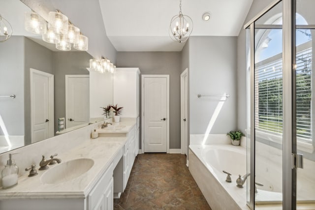 bathroom with vaulted ceiling, a chandelier, a tub to relax in, and vanity