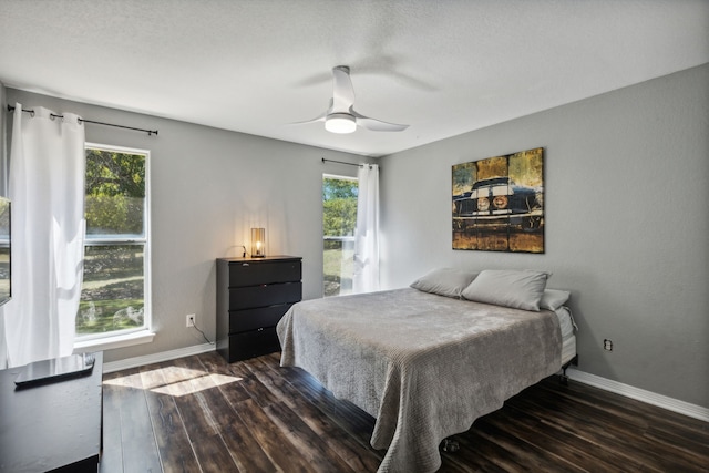 bedroom featuring ceiling fan and dark hardwood / wood-style flooring