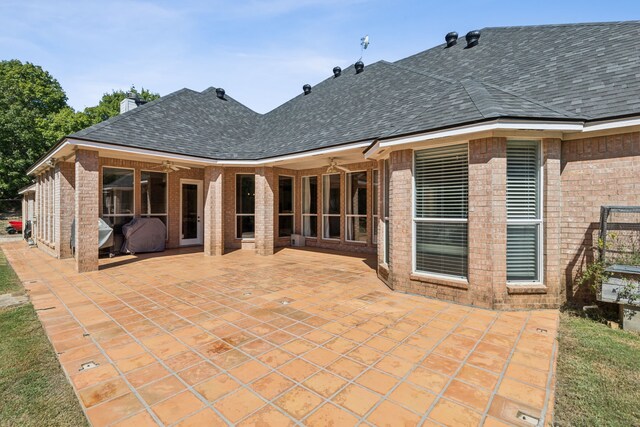 rear view of house featuring a patio area and a lawn