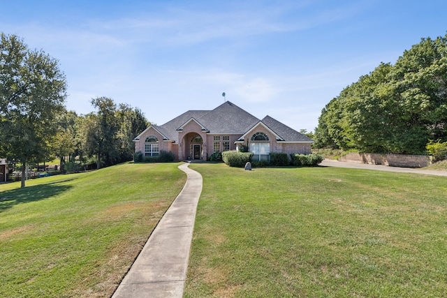 ranch-style home featuring a front lawn