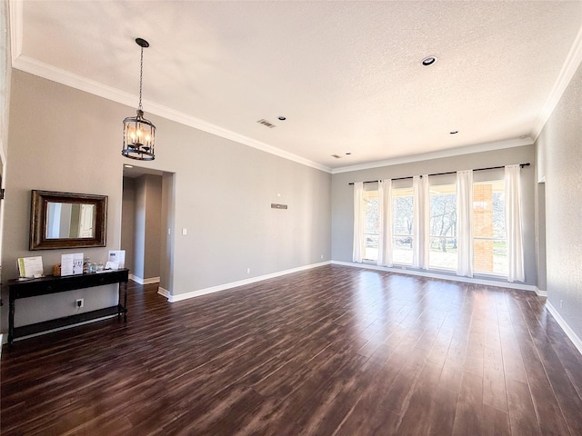 unfurnished living room featuring crown molding, dark hardwood / wood-style floors, and a notable chandelier