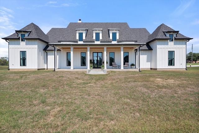 rear view of house featuring a patio and a yard