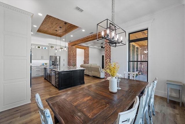 dining room featuring ceiling fan with notable chandelier, wood ceiling, dark hardwood / wood-style floors, and ornamental molding