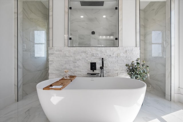 bathroom featuring separate shower and tub and tile walls