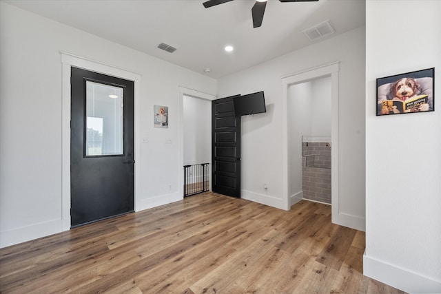 unfurnished bedroom with ceiling fan and light wood-type flooring