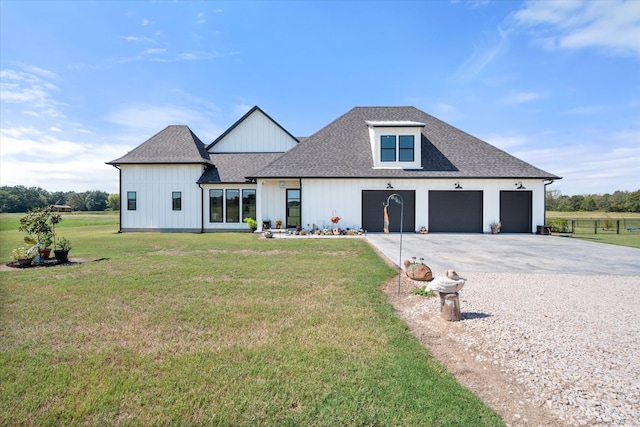 modern inspired farmhouse featuring a front yard and a garage