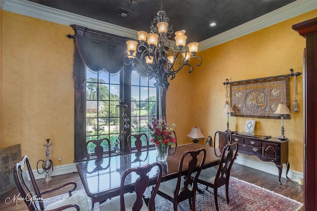 dining area featuring crown molding, wood-type flooring, and an inviting chandelier