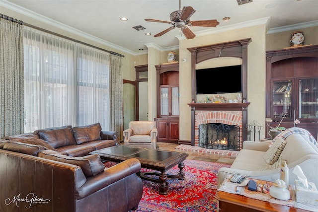 living room with crown molding, a fireplace, and ceiling fan