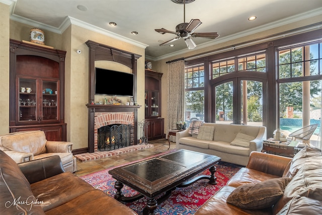 living room featuring ornamental molding, a fireplace, and ceiling fan