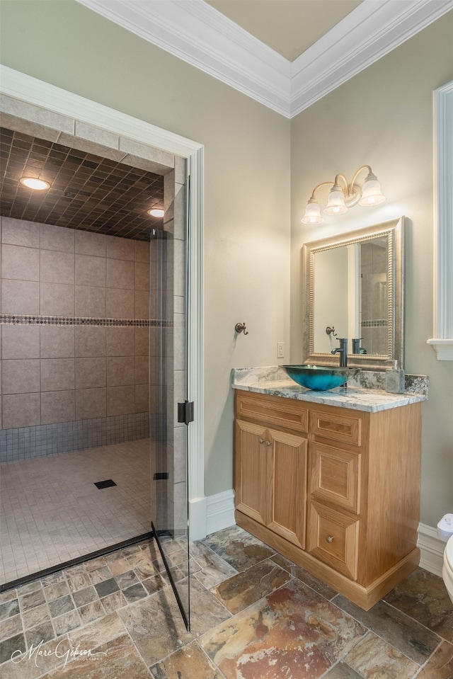 bathroom featuring vanity, crown molding, toilet, and tiled shower