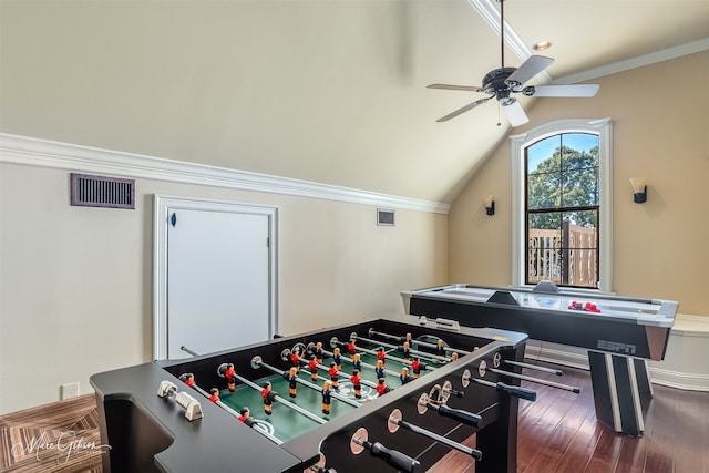 game room with ornamental molding, ceiling fan, dark wood-type flooring, and vaulted ceiling