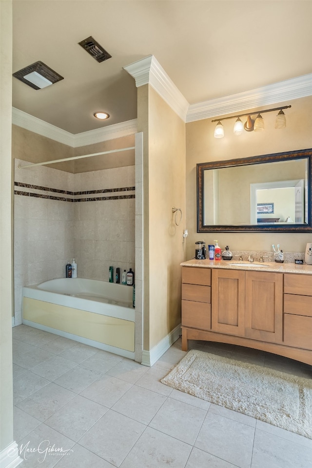 bathroom featuring tiled shower / bath, vanity, ornamental molding, and tile patterned flooring