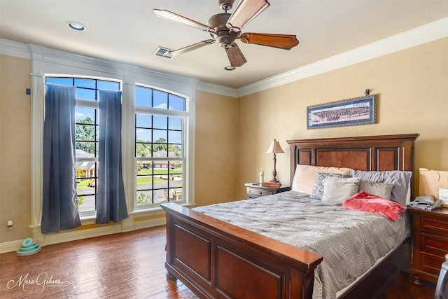 bedroom featuring dark hardwood / wood-style flooring, crown molding, and ceiling fan