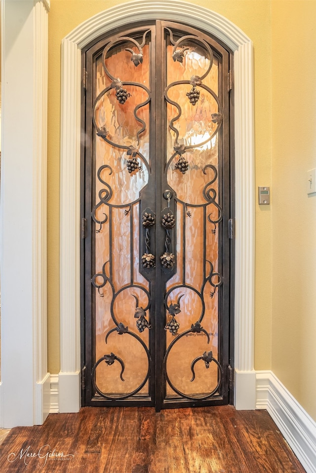 details with french doors and wood-type flooring