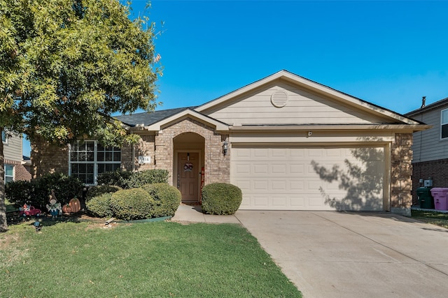 ranch-style home with a front yard, brick siding, driveway, and an attached garage