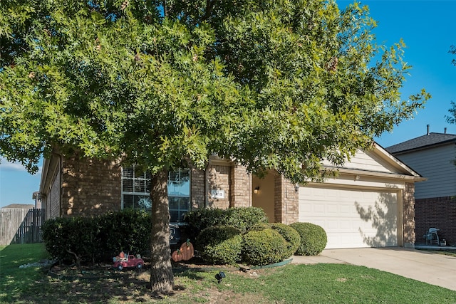 obstructed view of property with a garage, brick siding, fence, driveway, and a front lawn