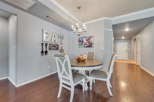 dining area featuring ornamental molding, dark hardwood / wood-style floors, and a chandelier