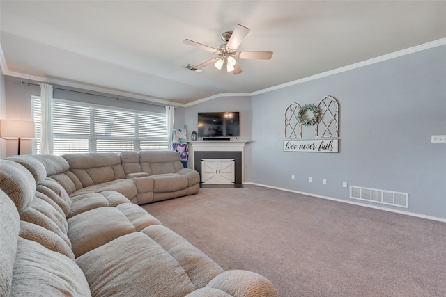 carpeted living room featuring crown molding, a fireplace, vaulted ceiling, and ceiling fan