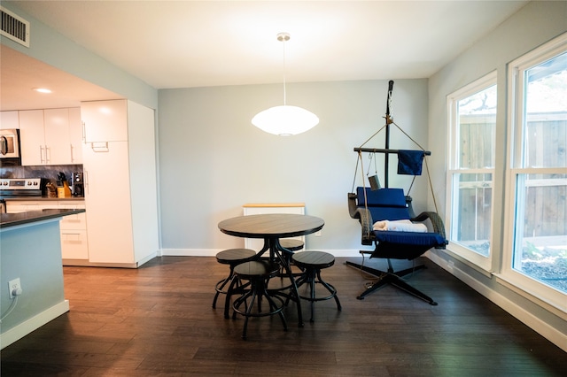 dining area with dark hardwood / wood-style floors