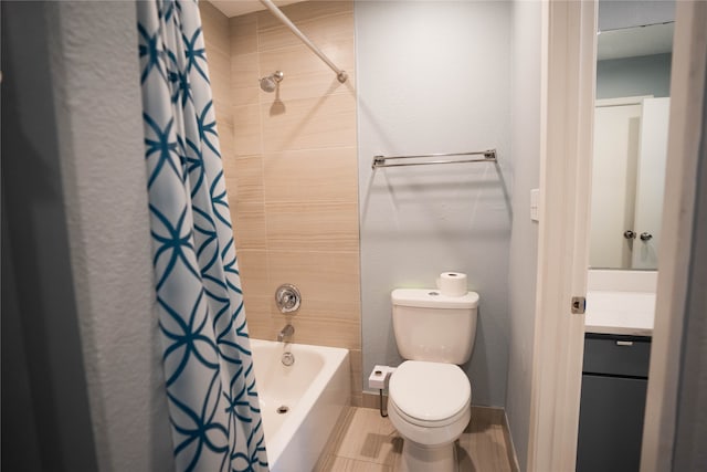 full bathroom featuring shower / bath combo, vanity, and toilet