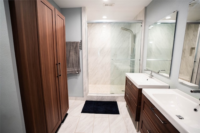 bathroom featuring tile patterned floors, an enclosed shower, and vanity