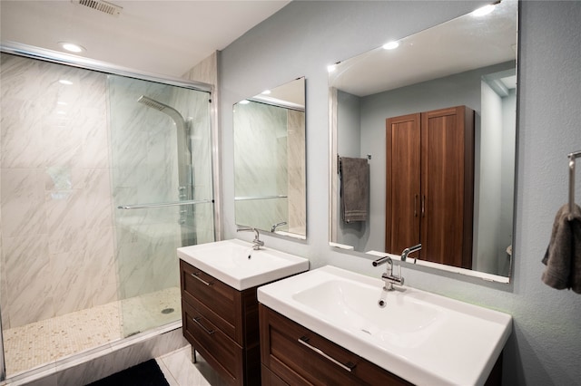 bathroom with a shower with shower door and vanity