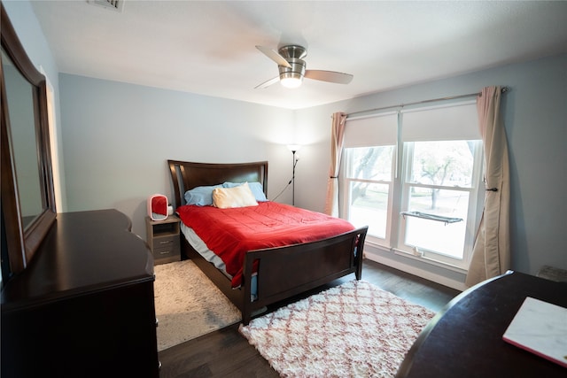 bedroom with ceiling fan and dark wood-type flooring